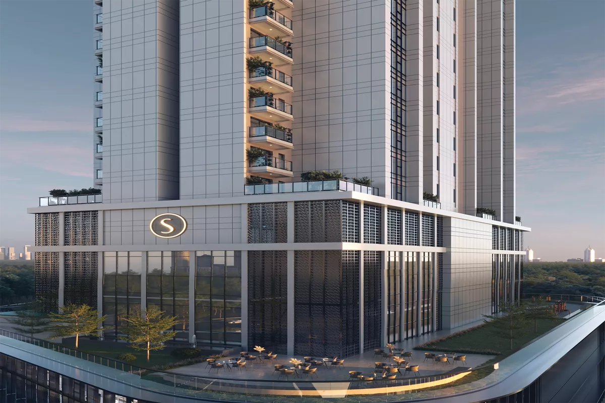 Sobha Strada commercial tower facade featuring modern glass architecture, outdoor retail seating area, and premium podium design.